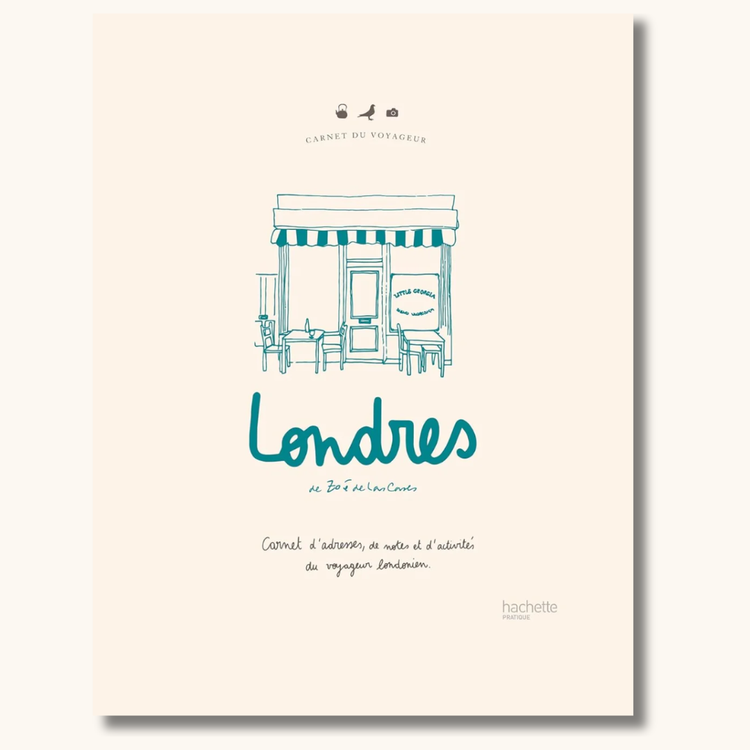 Beige hardcover rejsedagbog om London med turkis illustration af café og håndskrevet titel