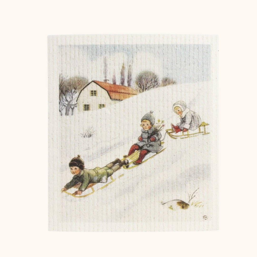 Creme karklud med vintermotiv af børn på kælkebakke, illustreret af Elsa Beskow