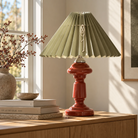 Antikrød opal glaslampe Petro med grøn plisseret skærm på trækommode